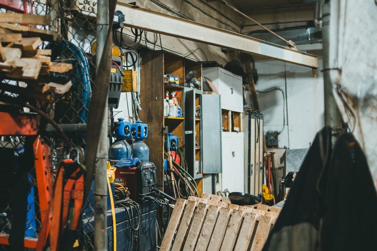 Inside a workshop filled with tools and equipment on shelves