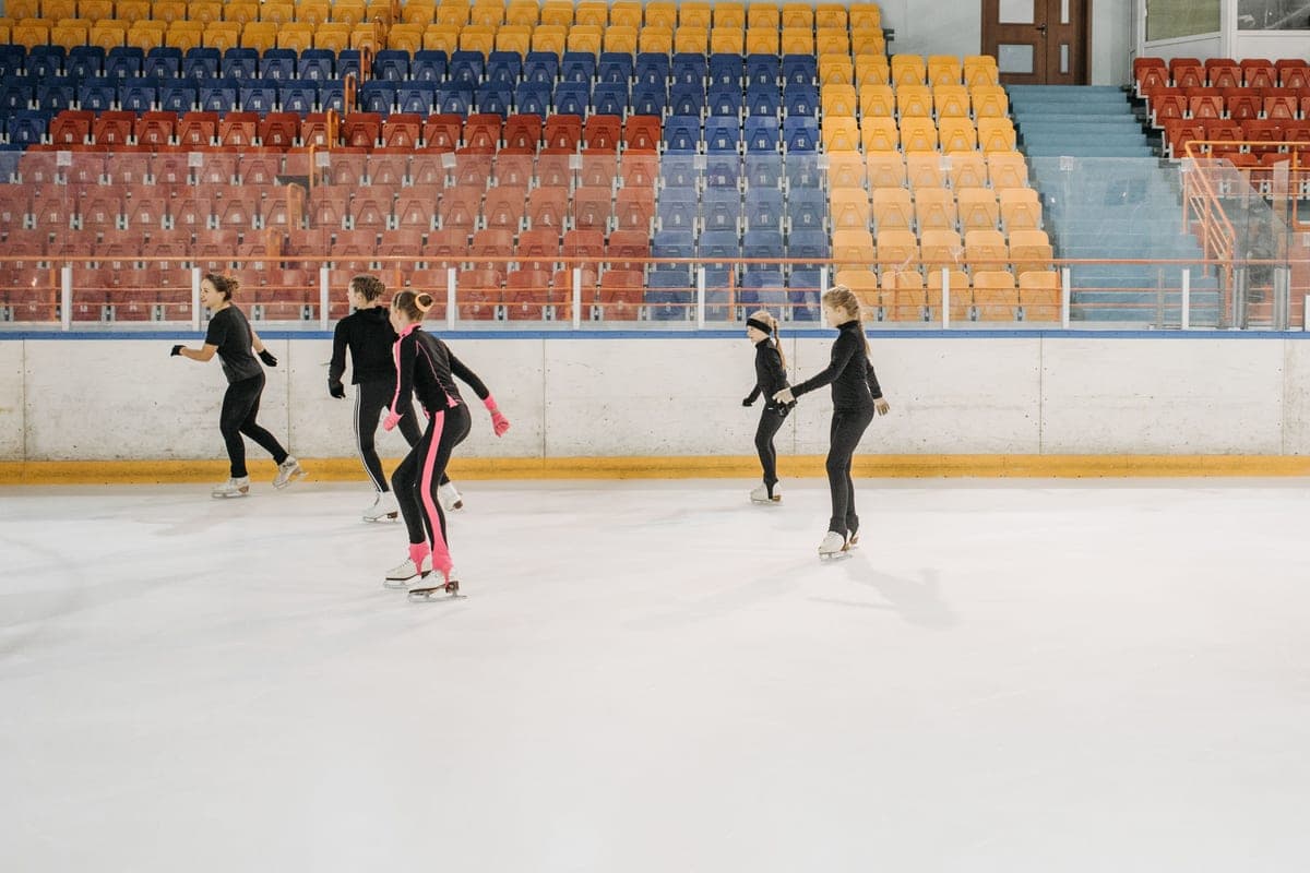 Young skaters practicing on an indoor ice rink