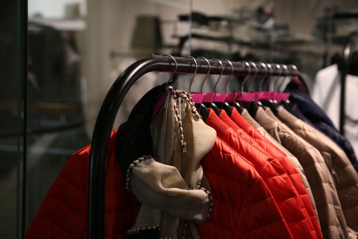 Colorful winter jackets hanging on a rack in a store