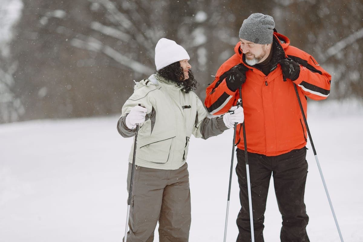 Two skiers together on a snowy slope in winter
