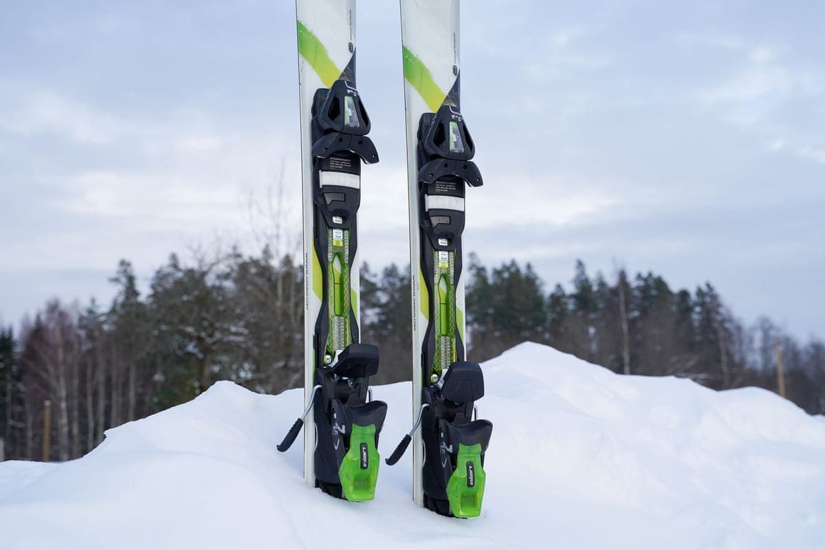 Close-up of skis resting in a snow-covered forest in winter