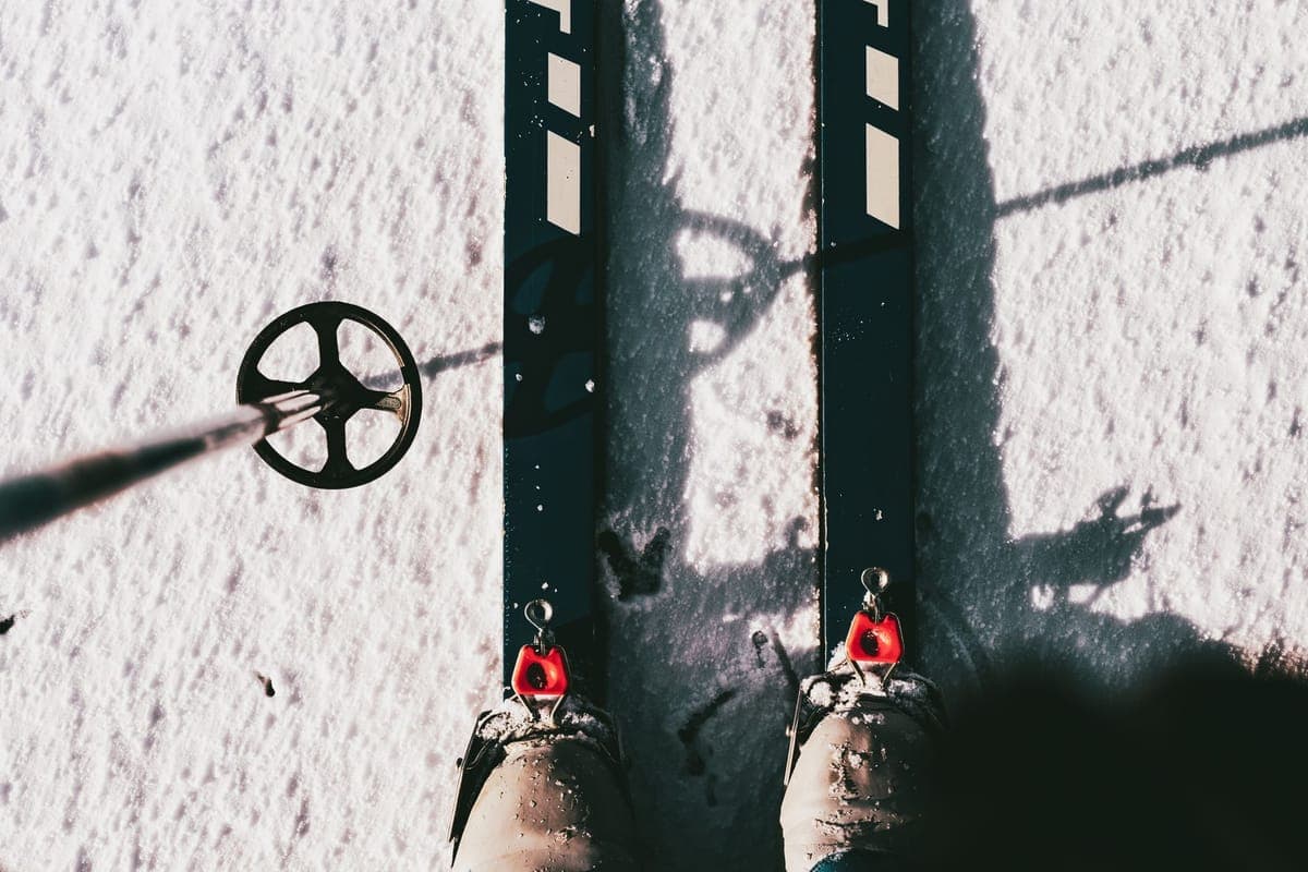 Ski equipment resting on snowy ground with bindings visible
