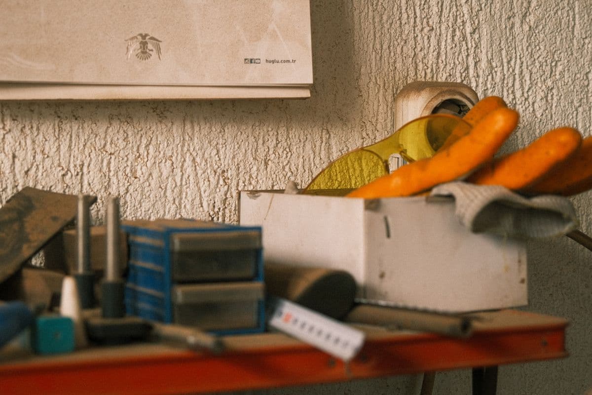 An organized workshop bench with hand tools and storage boxes