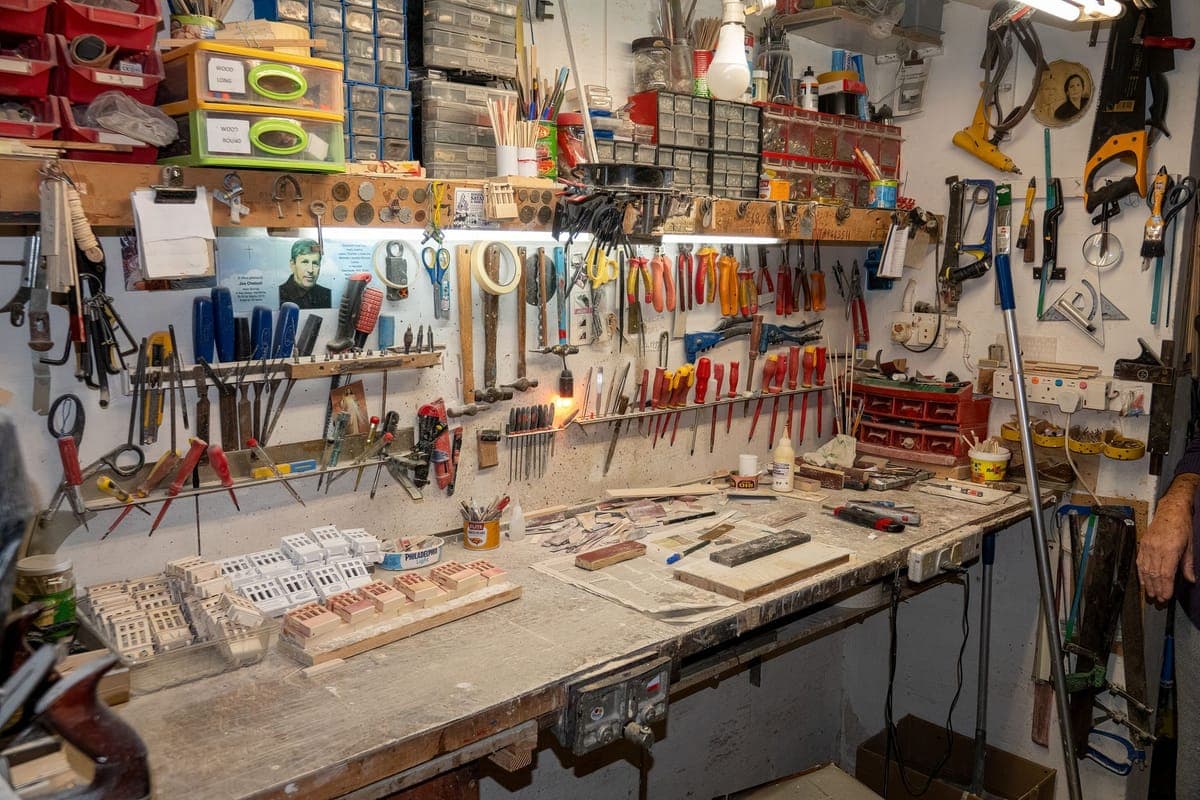 A well-organized workshop bench with tools and supplies laid out