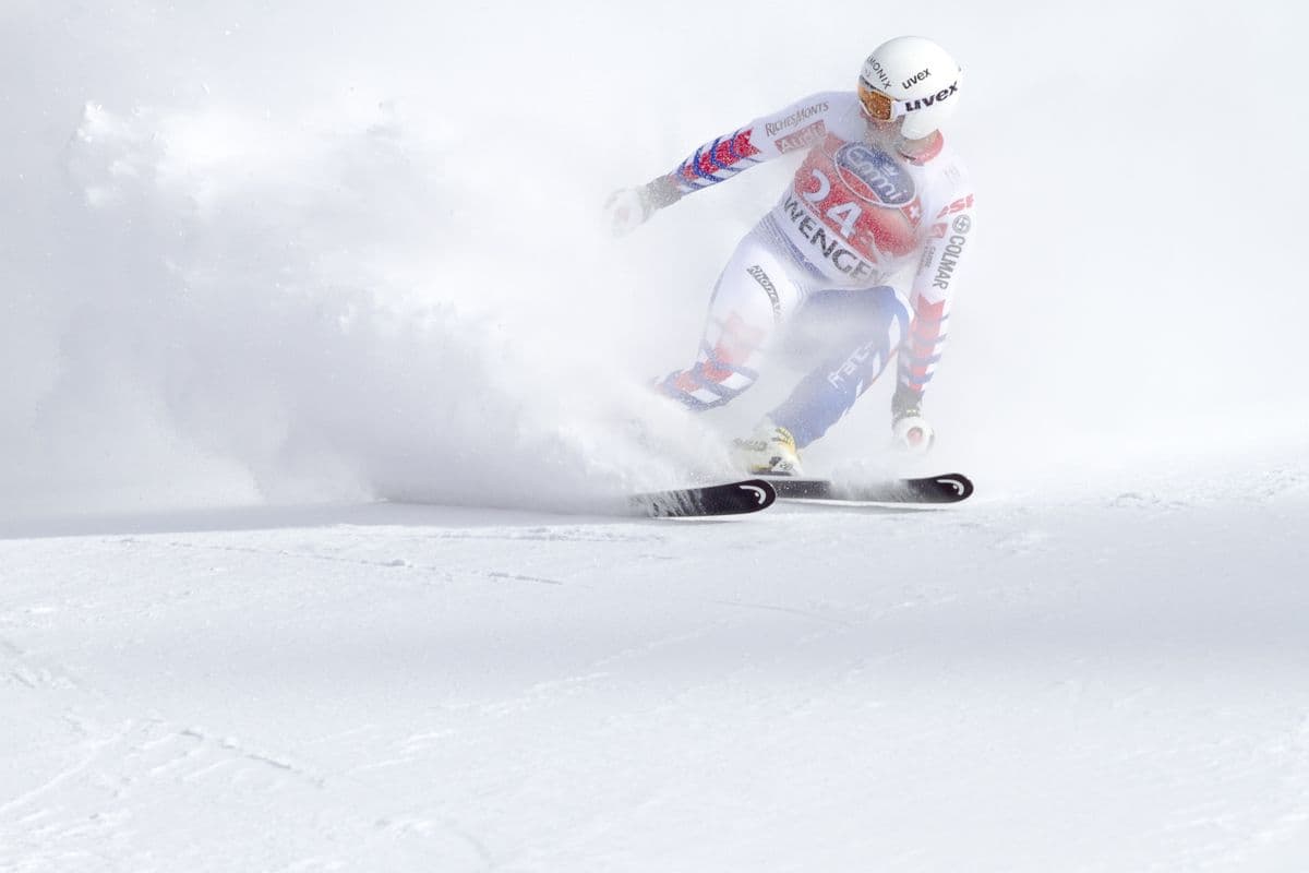 A skier in motion on a snowy slope during a winter sports day