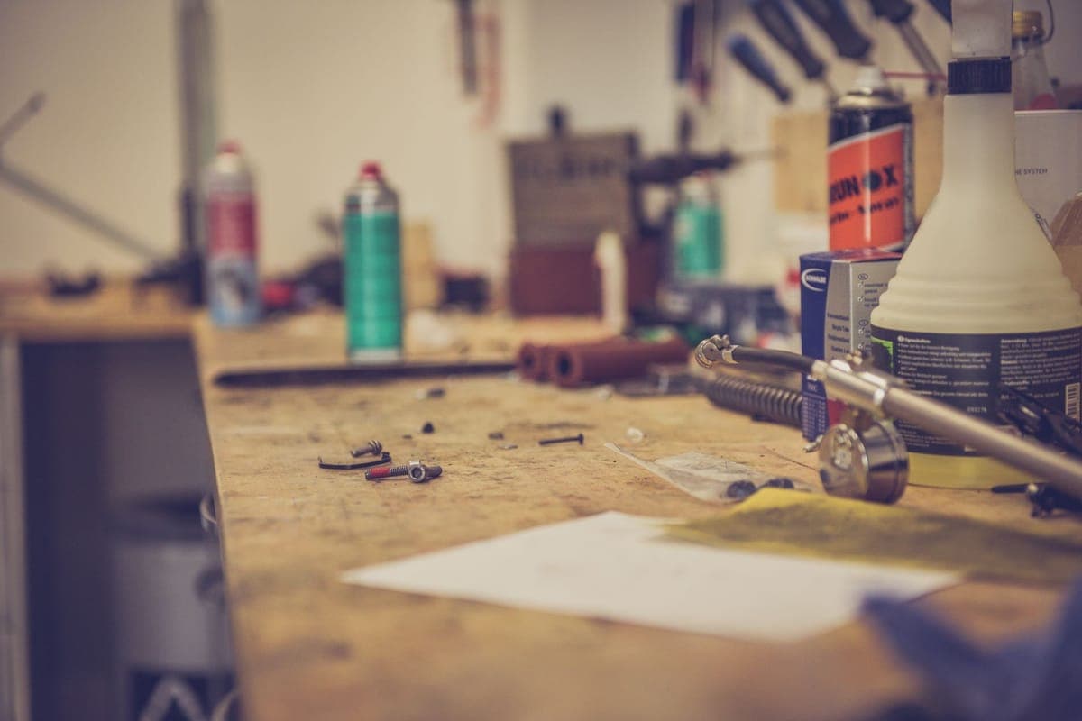 A workbench in a workshop with tools and materials laid out for maintenance