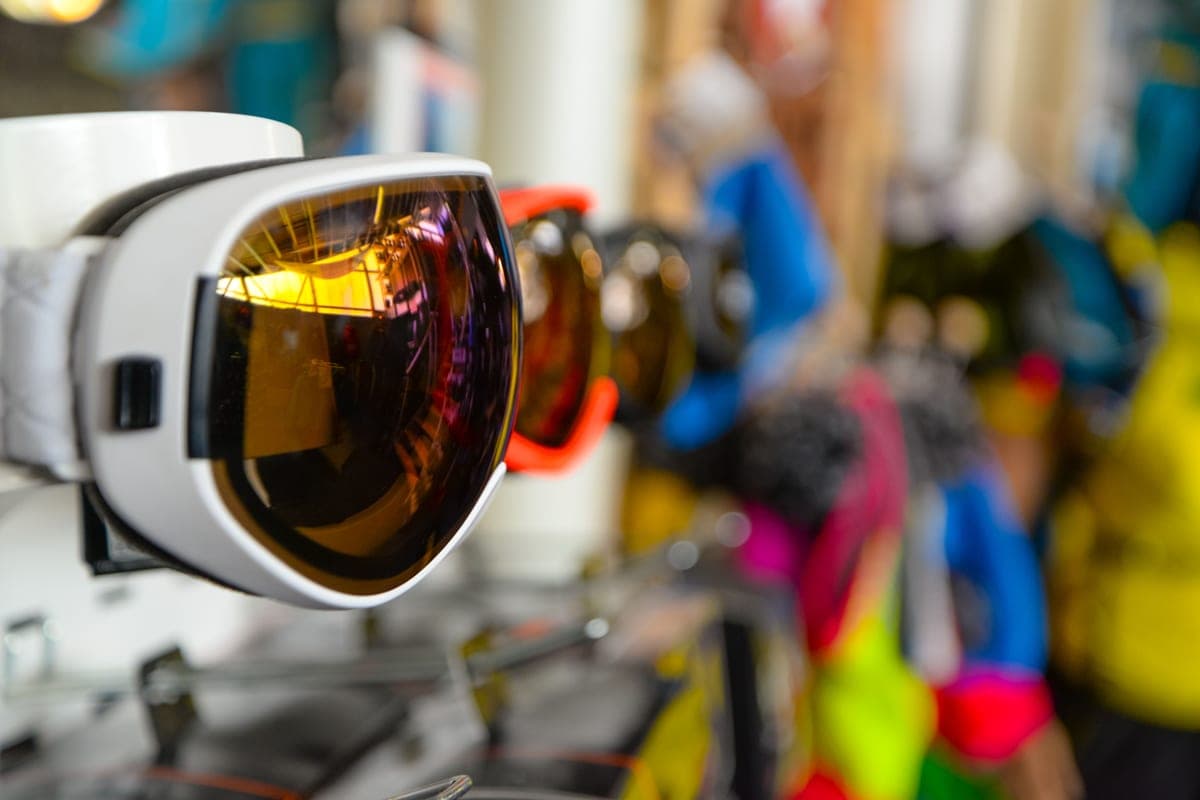 Ski goggles with reflective lenses displayed in a sports store