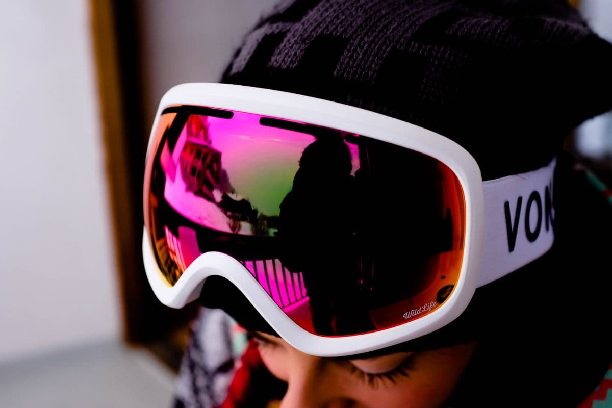 Ski goggles reflecting a bright snowy landscape