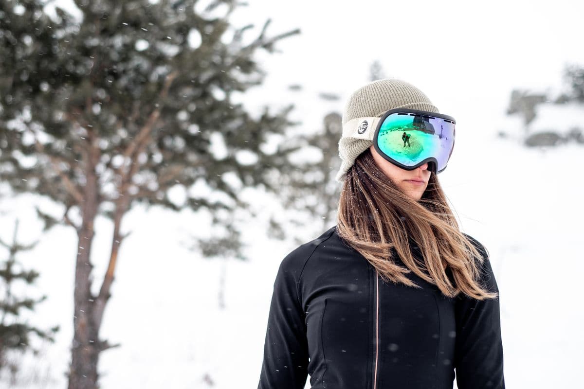 Outdoor portrait of a female skier in winter gear on a snowy day