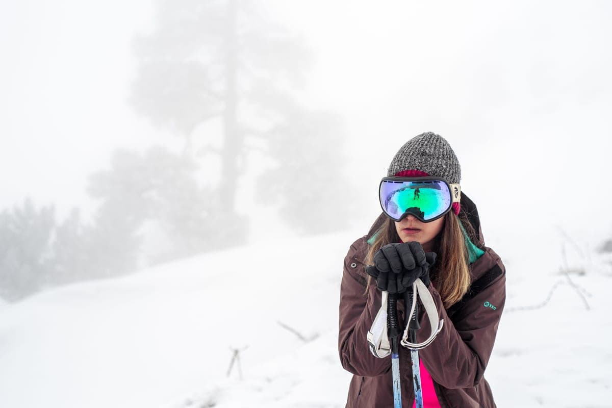 A skier in winter gear in a snowy landscape