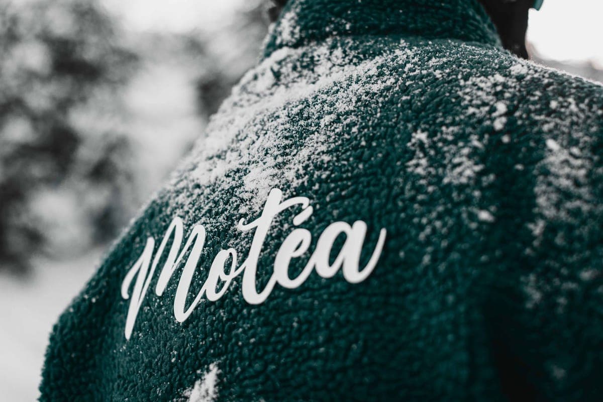 Close-up of a winter jacket dusted with snow on a cold day