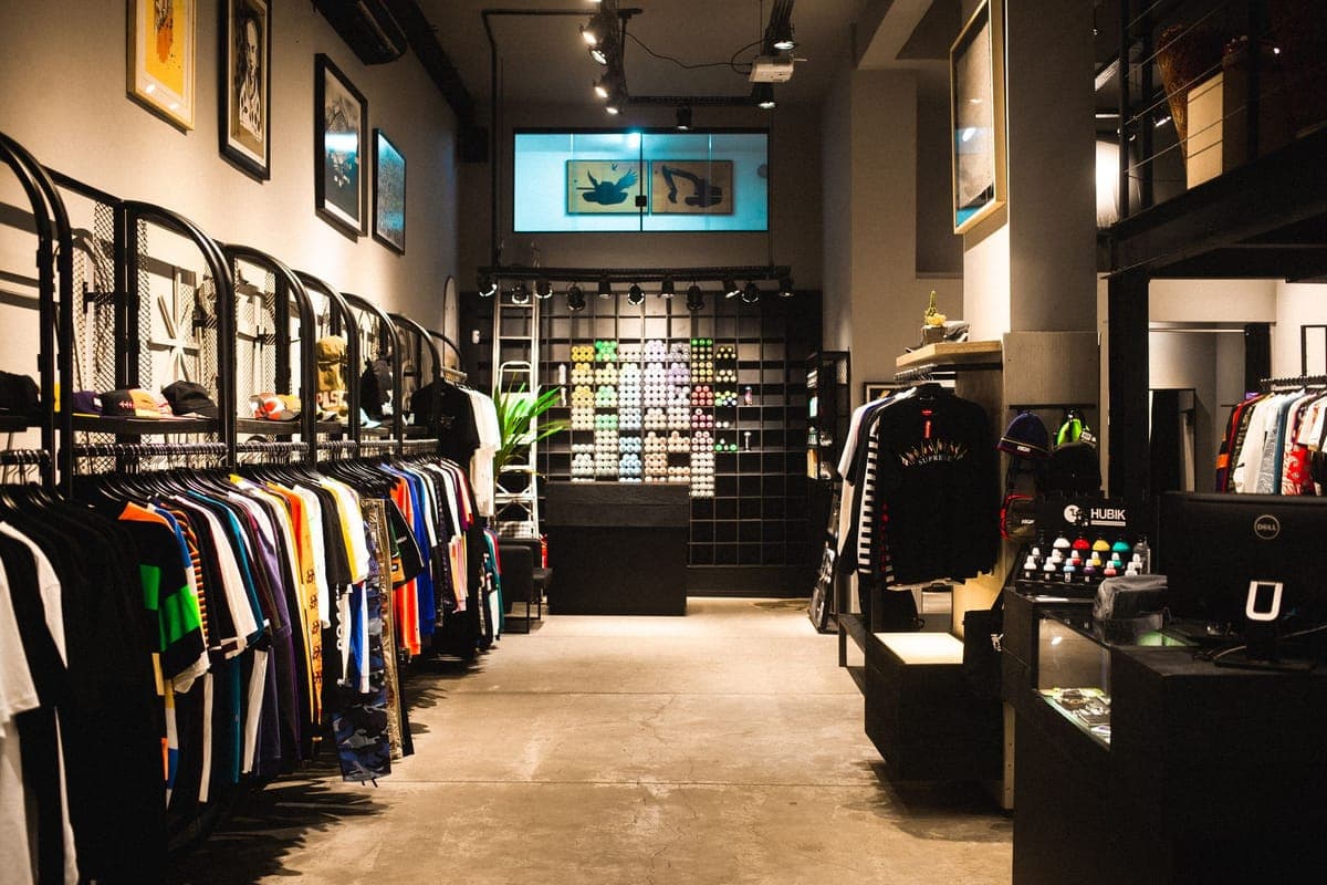 The interior of a clothing store with racks of garments on display