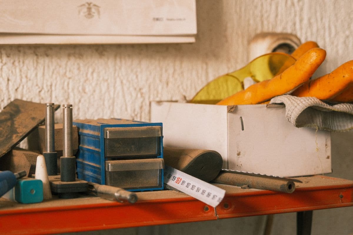 A wooden workbench laid out with hand tools in a workshop