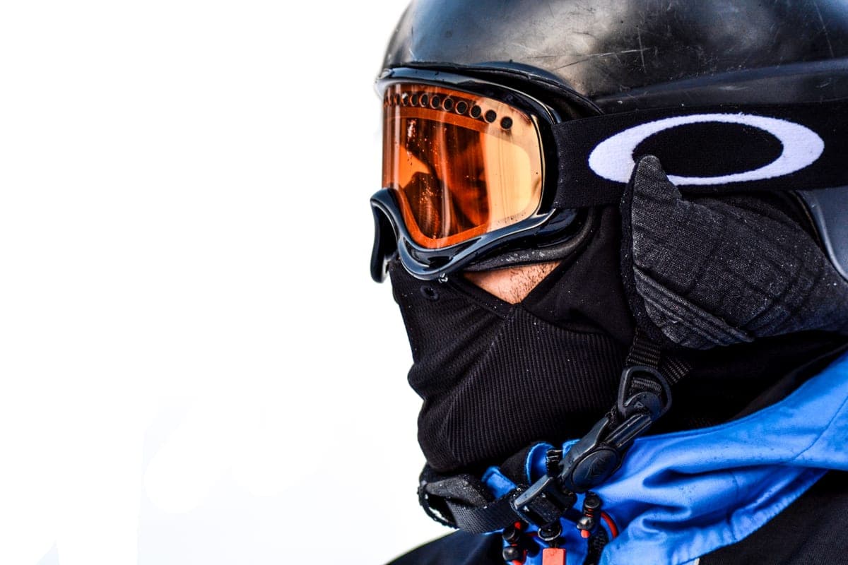 Close-up of a skier in protective winter gear and goggles